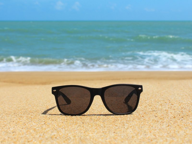 Black sunglasses on the beach