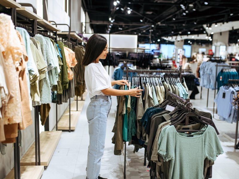 Woman choosing clothes in clothing store
